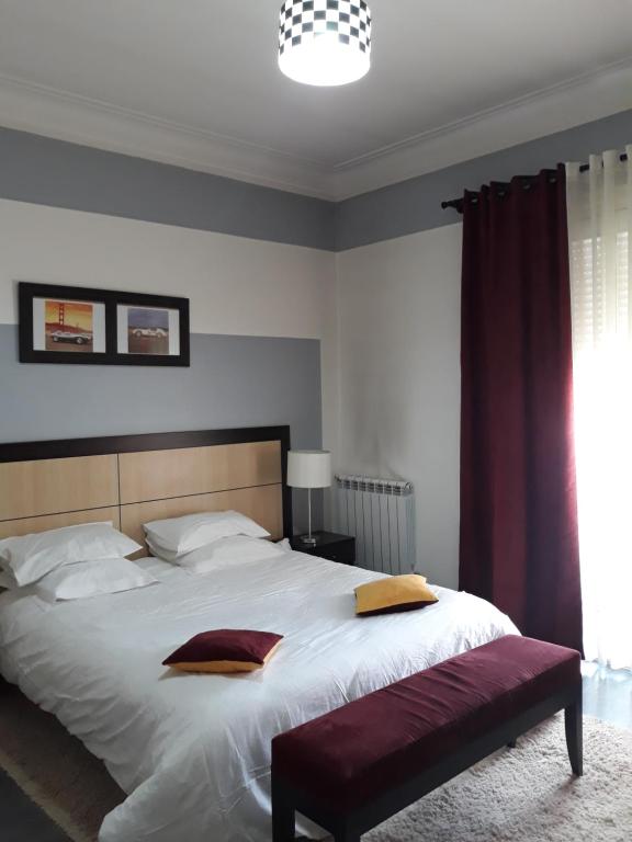 a bedroom with a large white bed and a window at RESIDENCE Paradise in Fort de lʼEau