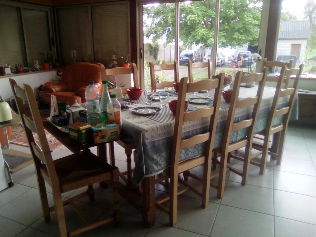 a dining room table and chairs with a table and a table and chairs at GUERINEL HERBERT PIERRETTE in Hirel