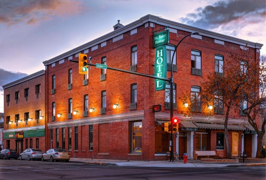 a red brick building with a green street sign on it at The Baker Hotel in Cranbrook