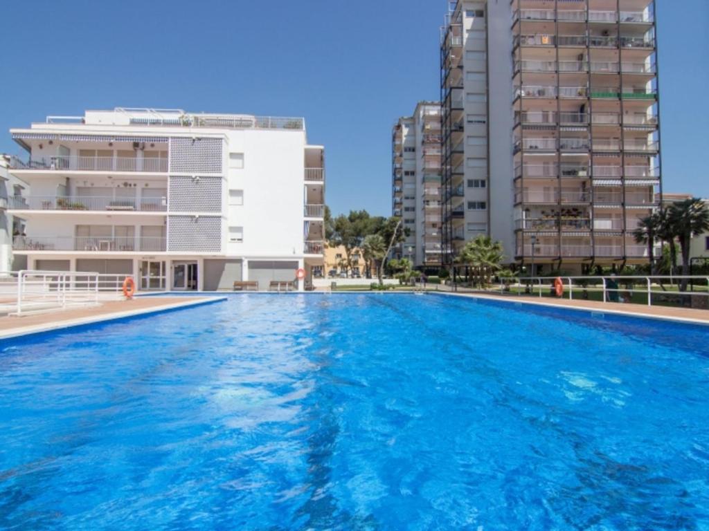 a large swimming pool in front of some buildings at Sol & Relax en centro, Sitges. in Sitges