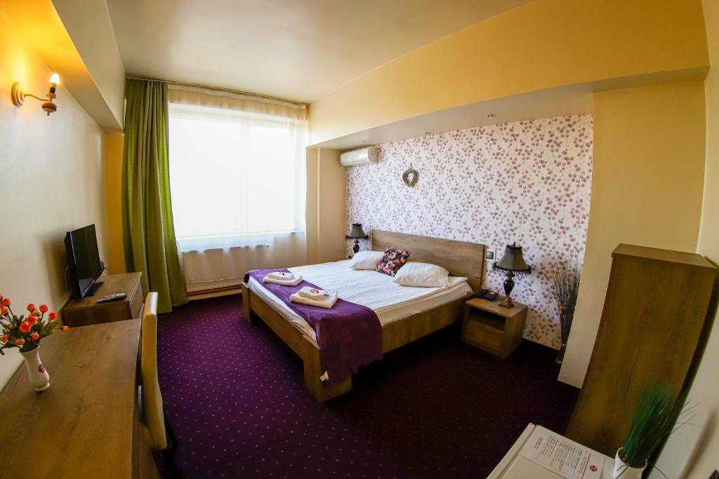 Postel nebo postele na pokoji v ubytování Hotel Olimp