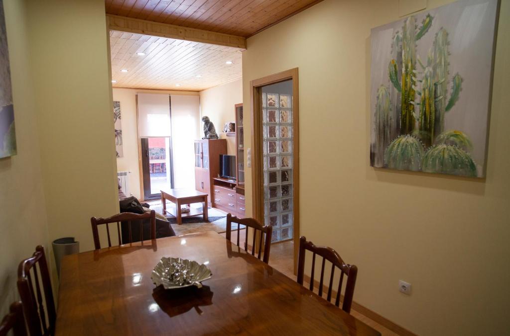 a dining room with a wooden table and chairs at Casa Chuss in Sober