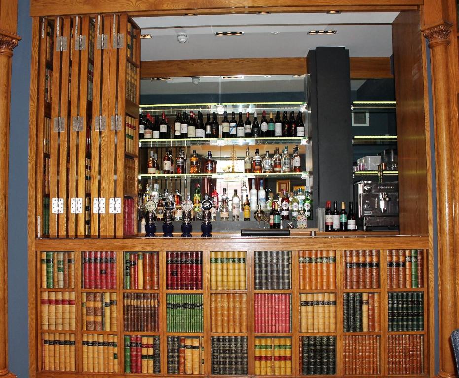 a bar filled with lots of bottles of alcohol at The Raeburn in Edinburgh