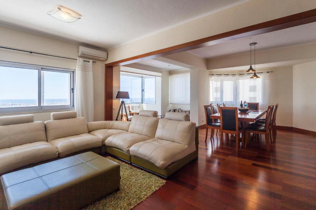uma sala de estar com um sofá e uma mesa em Deluxe Marina Apartment - Azorean Butler em Ponta Delgada