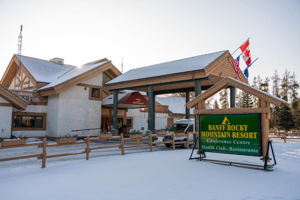 a lodge property with a sign in front of a building at Banff Rocky Mountain Resort in Banff