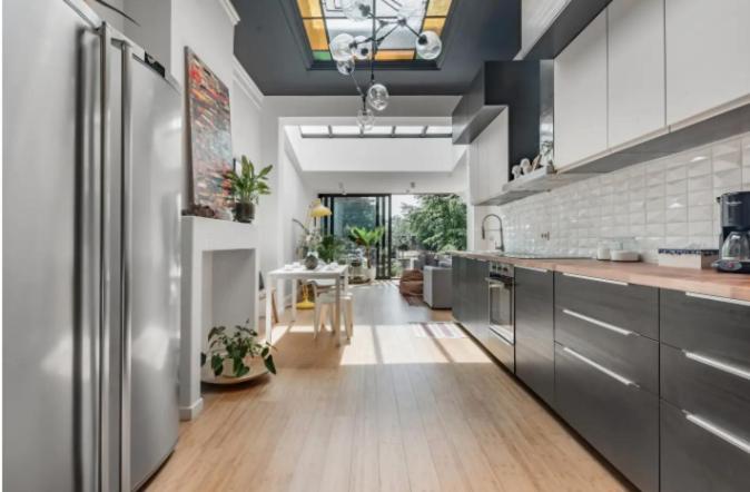 a large kitchen with stainless steel appliances and a table at Flemishome, The Retreat For Family And Friends in Halle