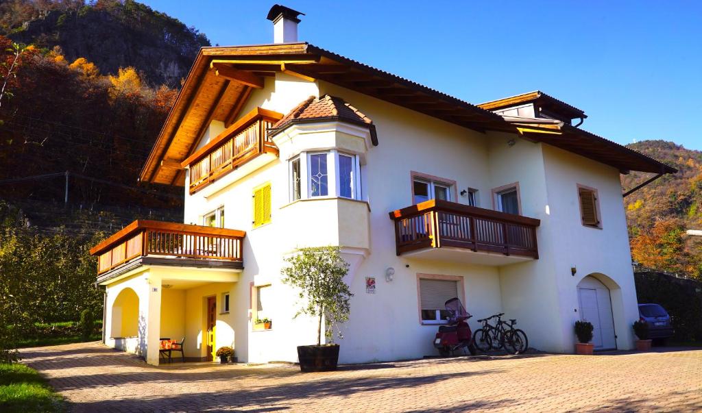 a white house with balconies on the side of it at Unterbi Apartments in Appiano sulla Strada del Vino