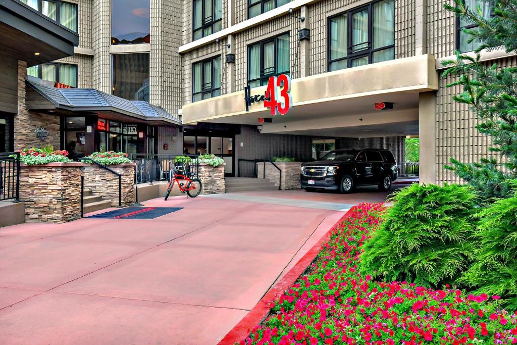 a large building with a patio area with tables and chairs at Hotel 43 Boise in Boise