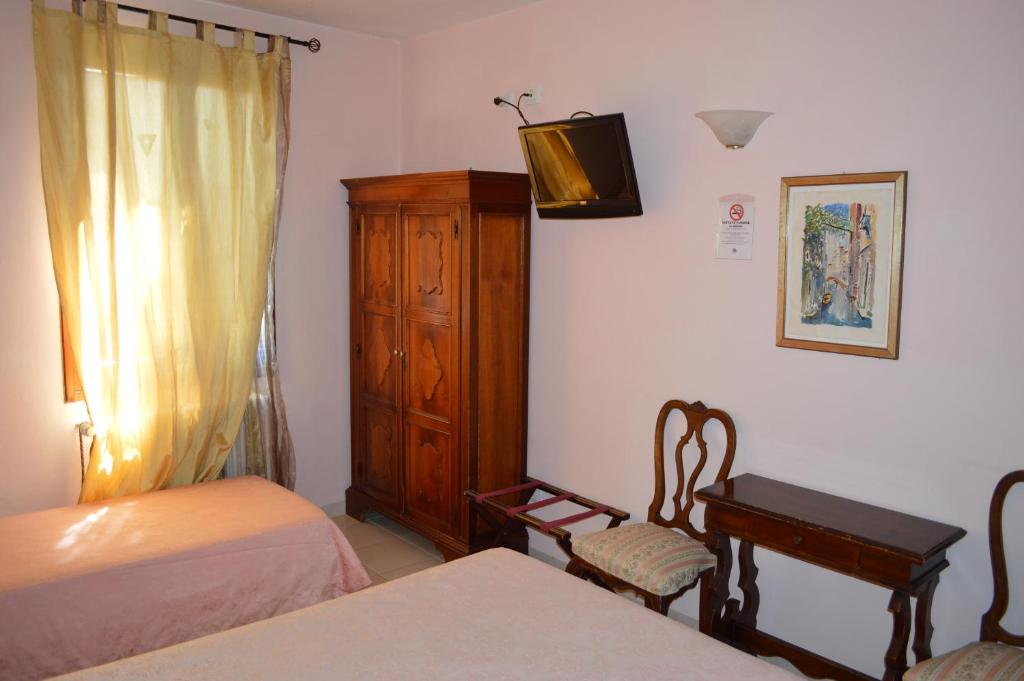 Postel nebo postele na pokoji v ubytování Hotel Locanda Salieri
