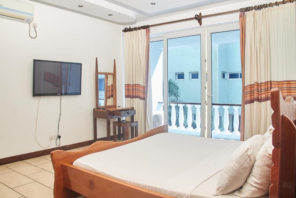 Säng eller sängar i ett rum på Stylish Beachfront Apartment Mombasa King Sized bed