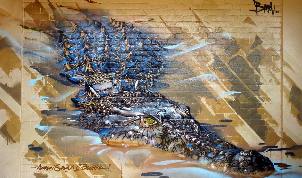 a painting of a crocodile on a wall at Walkabout Lodge in Nhulunbuy