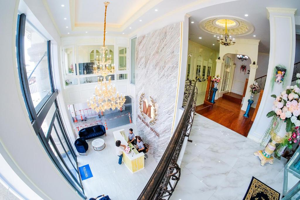 an overhead view of a living room with a chandelier at The MACEO Hotel in Nong Khai