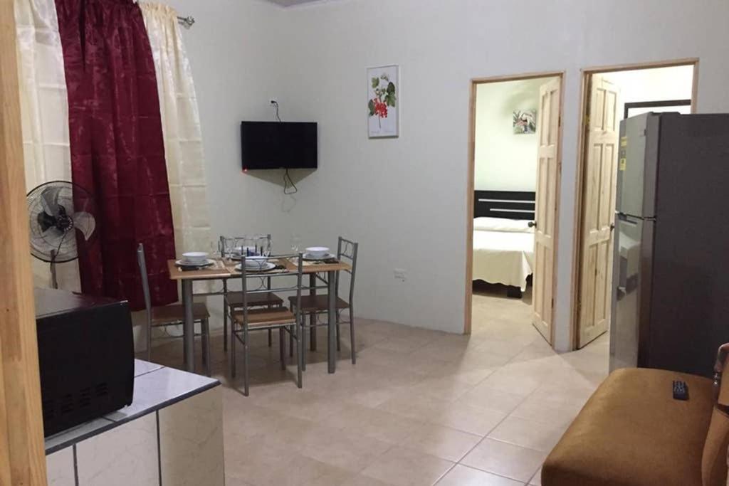 a living room with a kitchen and a dining room at Los Sueños RyG 3 in Quepos