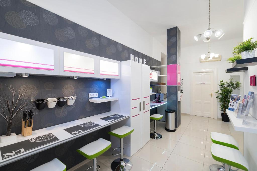 a kitchen with green stools in a room at Studio 4U Apartment in Budapest