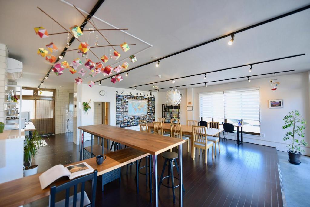 a large room with tables and chairs in it at Ise Guest House Sora in Ise