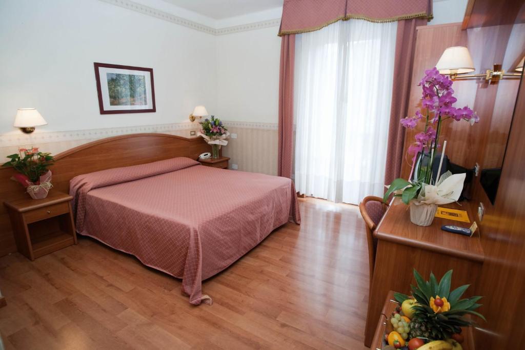 Postel nebo postele na pokoji v ubytování Hotel Villa Mulino ***S