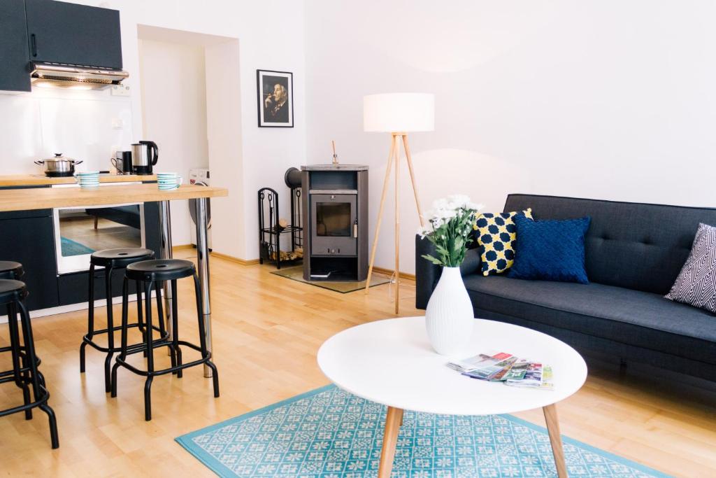 a living room with a couch and a table at Bright, central and stylish city apartment in Vienna