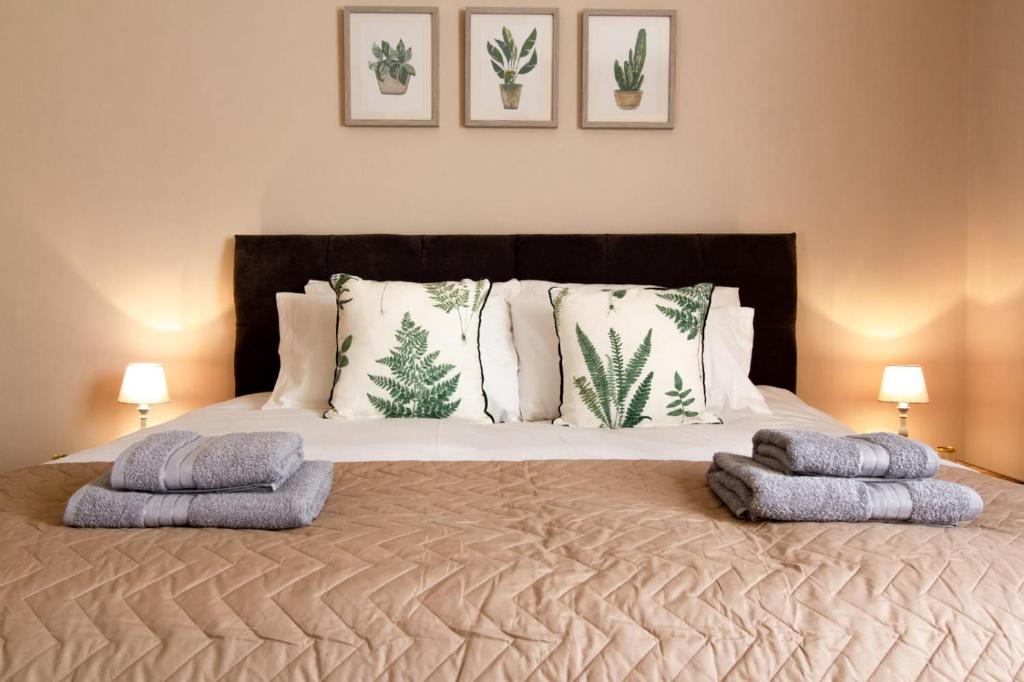 a bedroom with a large bed with two pillows on it at William House in Chester