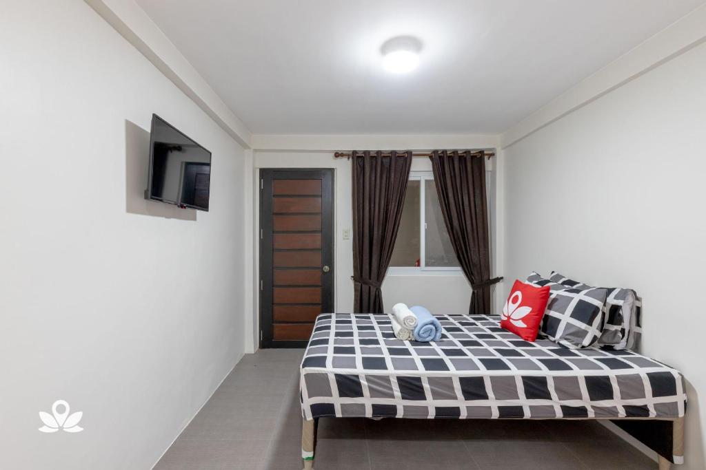 Postel nebo postele na pokoji v ubytování Happy Grey Hotel Vigan