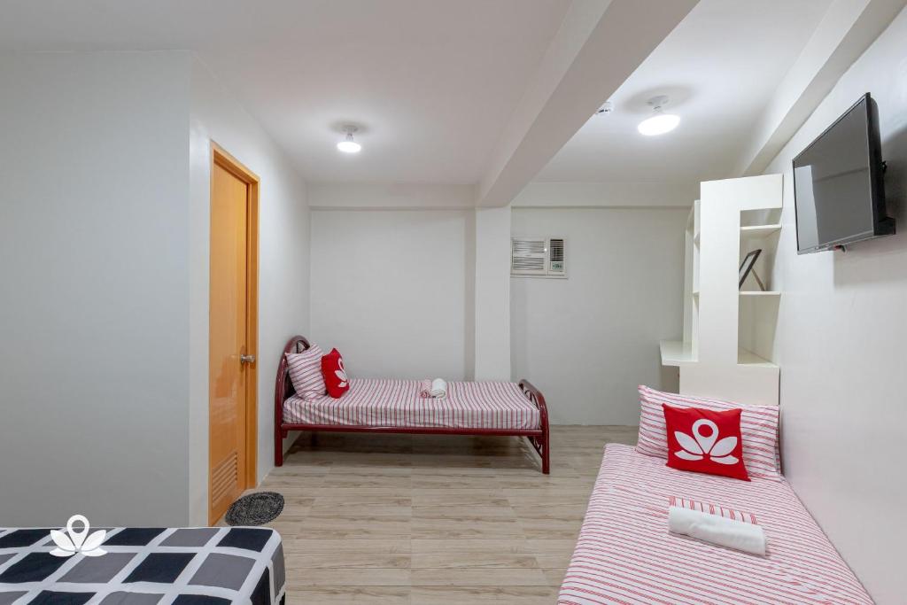 Postel nebo postele na pokoji v ubytování Happy Grey Hotel Vigan