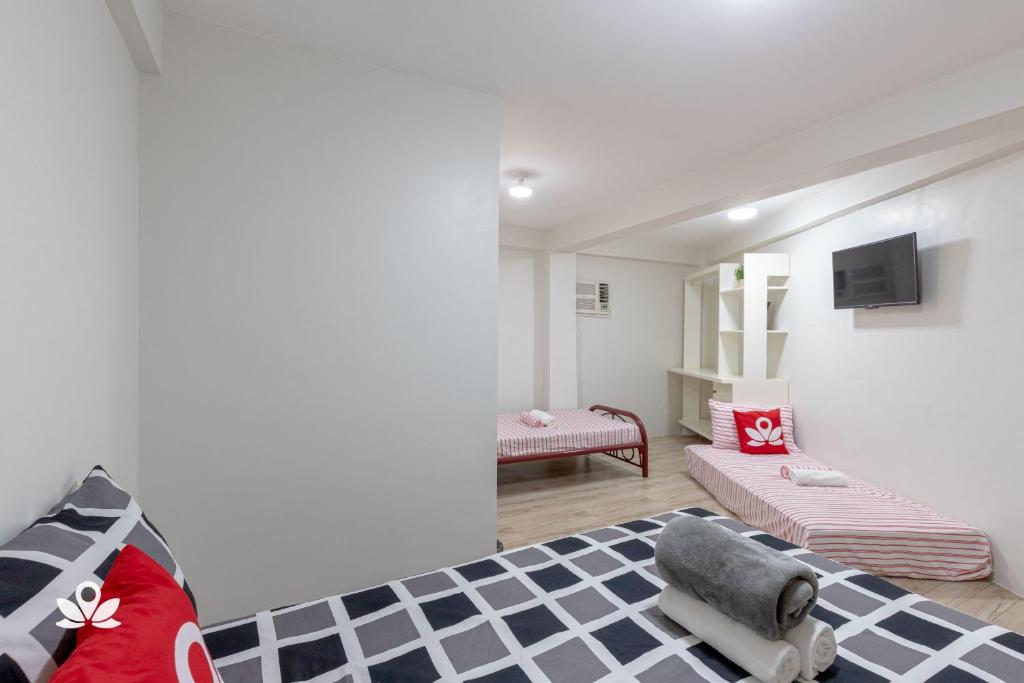 Postel nebo postele na pokoji v ubytování Happy Grey Hotel Vigan