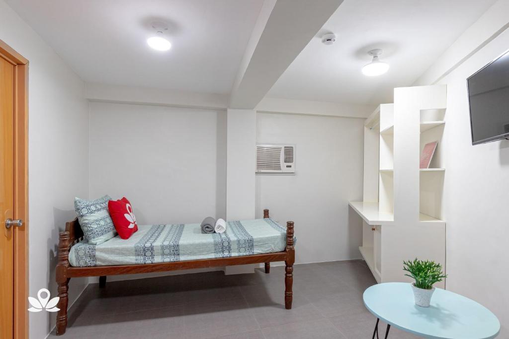 Postel nebo postele na pokoji v ubytování Happy Grey Hotel Vigan