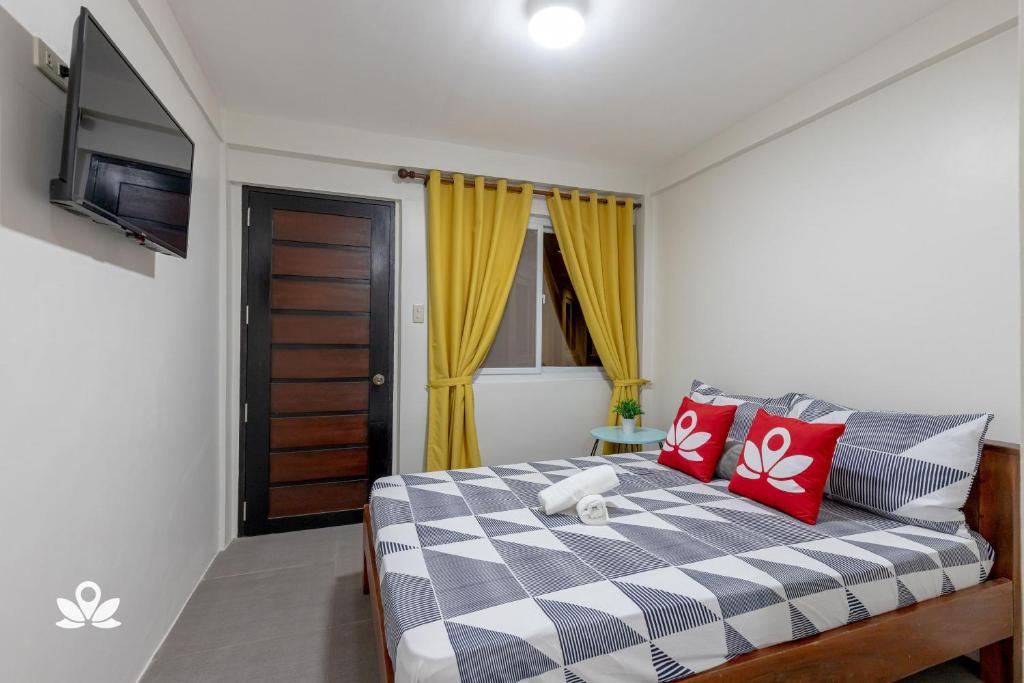 Postel nebo postele na pokoji v ubytování Happy Grey Hotel Vigan