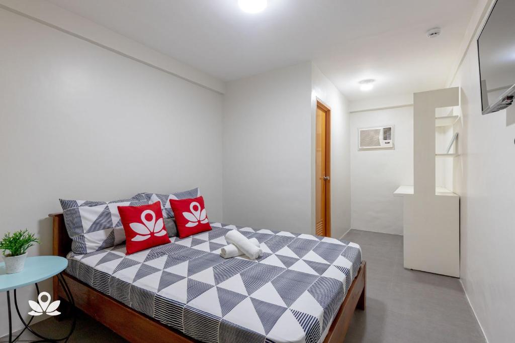 Postel nebo postele na pokoji v ubytování Happy Grey Hotel Vigan