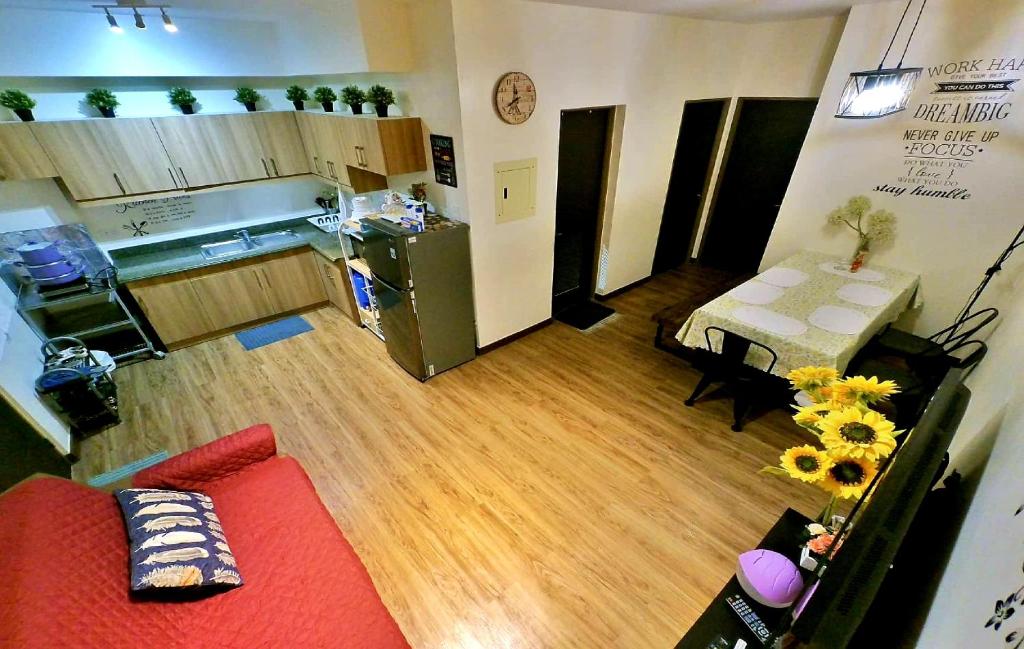 碧瑤的住宿－DMCI Bristle Ridge Condo 318 Cozy 2 Bedroom Unit，一间带红色沙发的客厅和一间厨房