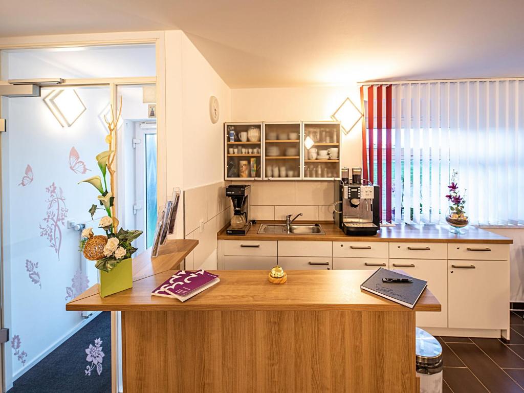 a kitchen with a wooden counter top in a room at Pension zum Bergmann in Böhlen