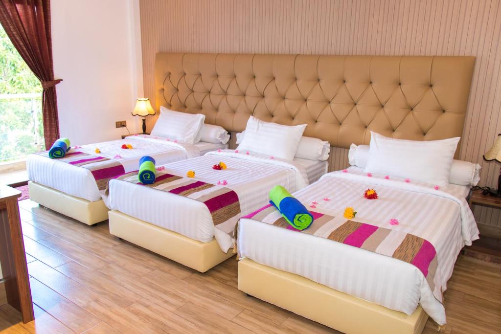 Postel nebo postele na pokoji v ubytování Rosy Villa Hotel