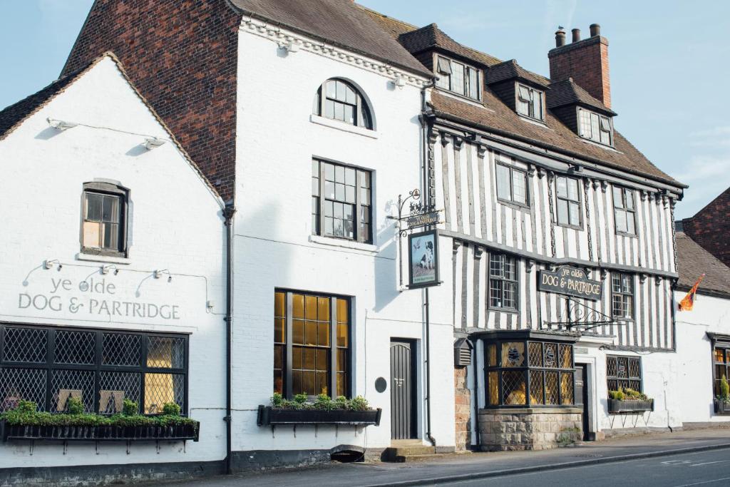 a white building with a dog and furniture store at Dog & Partridge by Chef & Brewer Collection in Tutbury
