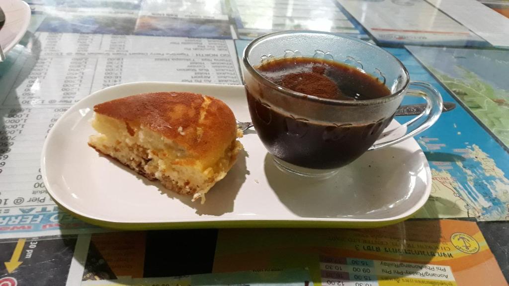 a plate with a piece of cake and a cup of coffee at New Andaman Bay Bungalow in Ko Lanta