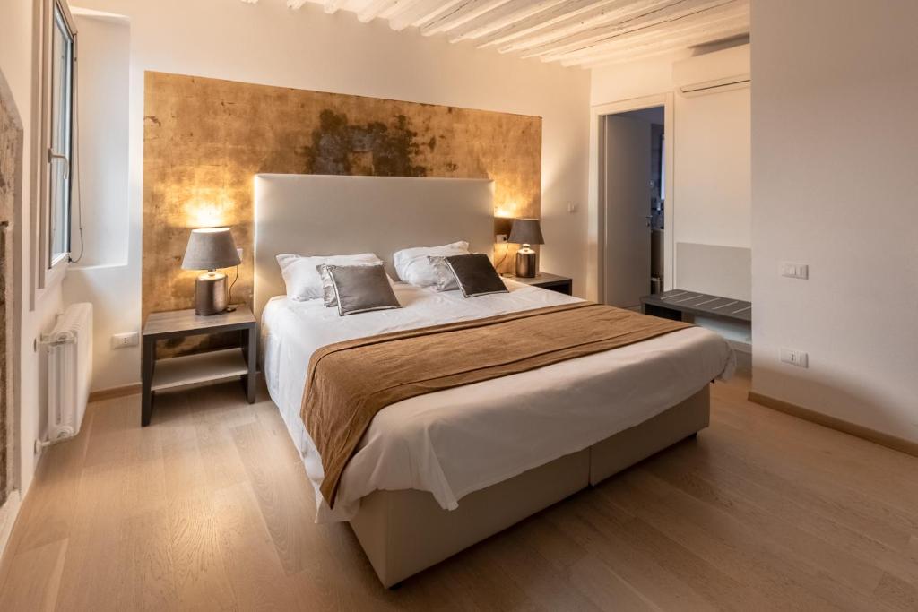a bedroom with a large bed with two pillows at Cà Del Tentor in Venice