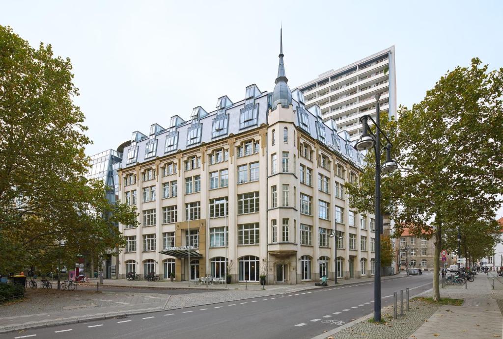 a large white building on the side of a street at Classik Hotel Alexander Plaza in Berlin