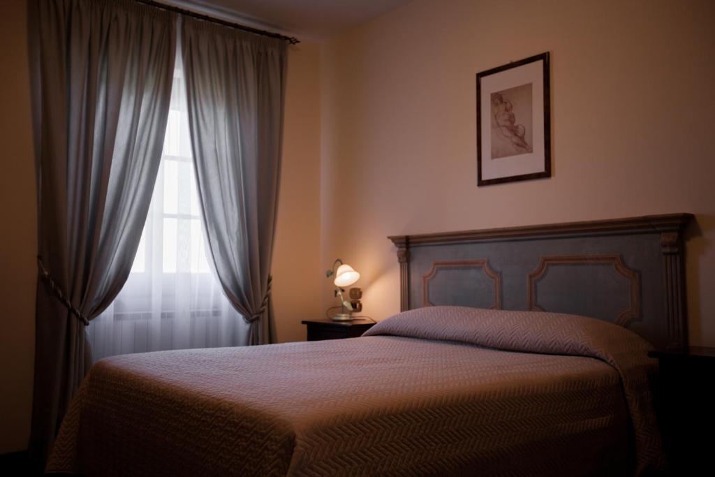A bed or beds in a room at Agriturismo Le Anfore