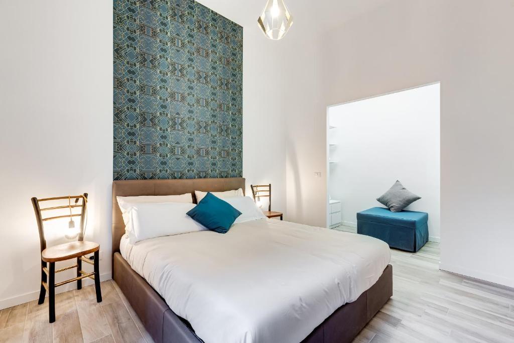 sypialnia z dużym łóżkiem i krzesłem w obiekcie BDC - Termini Sun Apartment w Rzymie