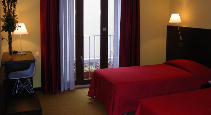 Uma cama ou camas num quarto em Albergo Verdi