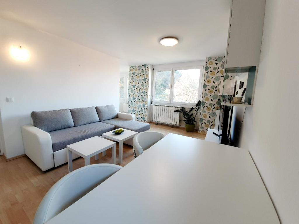a living room with a couch and a table at Bossa nova Castle&Outstanding home with garage in Ljubljana