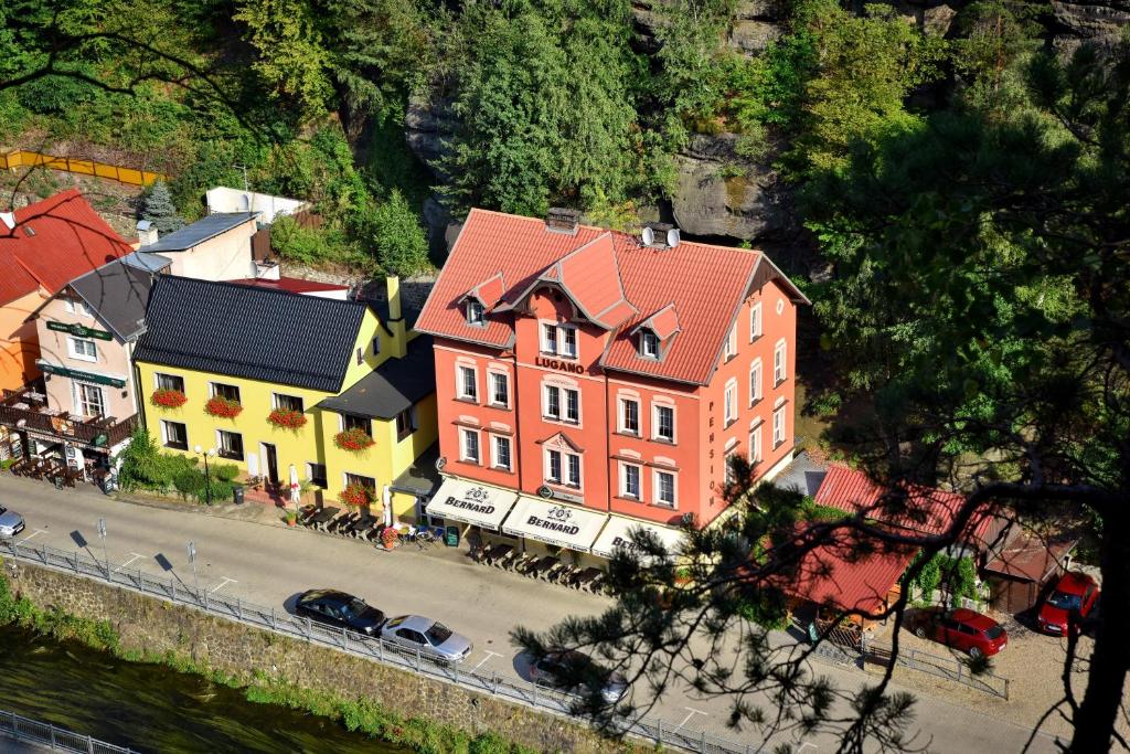 an aerial view of a building with a street and cars at Pension-Restaurace Lugano in Hřensko
