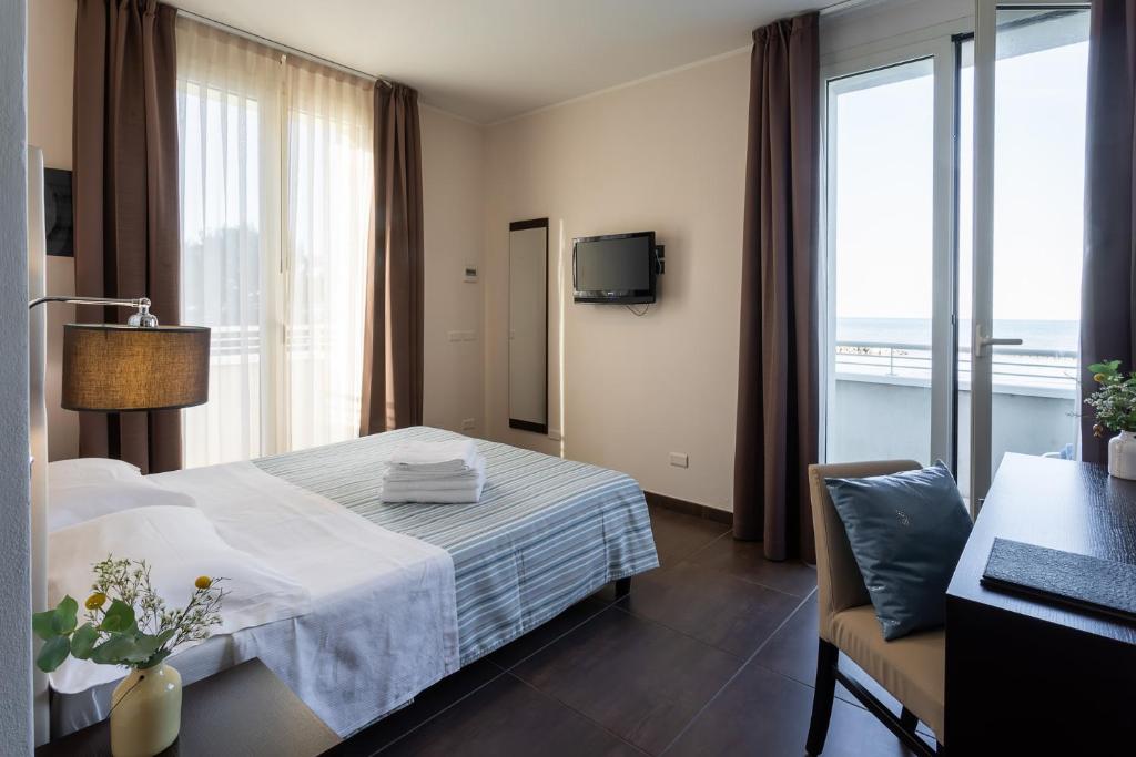 a hotel room with a bed and a window at Gimmi Hotel in Rimini