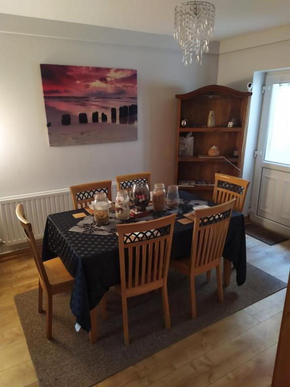 a dining room with a table with chairs and a chandelier at Mountjoy House in Derry Londonderry