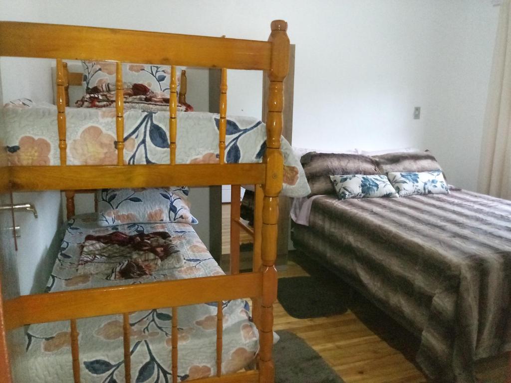 a bedroom with two bunk beds and a couch at Casa da NONNA in Gramado