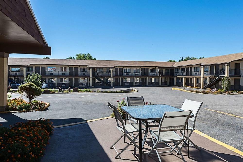 a table and chairs in front of a building at Lotus by Hotel Inn in Beaver