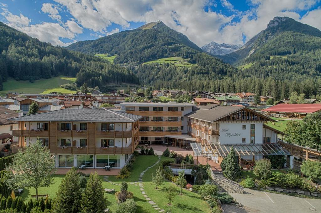 an aerial view of a town with mountains in the background at Hotel Alpenblick in Lutago