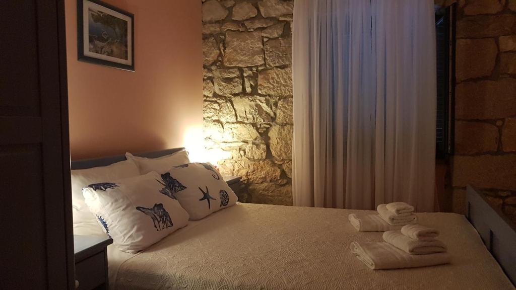 a bedroom with a bed with towels on it at Apartment Tomecek in Selce