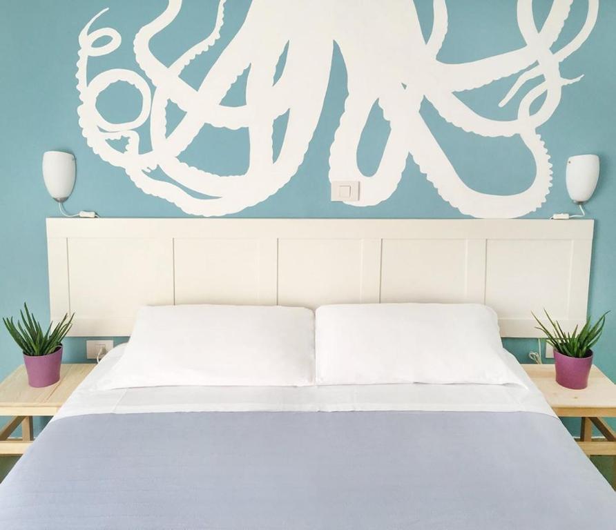 Postel nebo postele na pokoji v ubytování Hotel Aloha