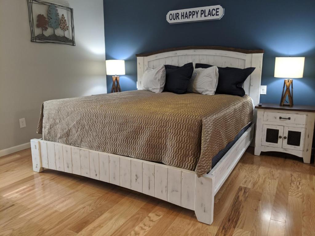 a bedroom with a large white bed with two lamps at Heidi Motel - Helen in Helen