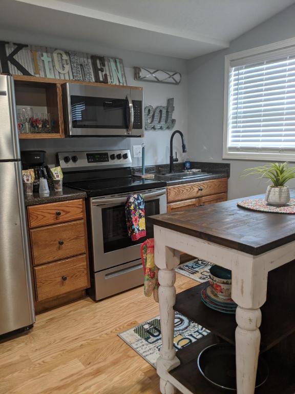 a kitchen with stainless steel appliances and a table at Heidi Motel - Helen in Helen