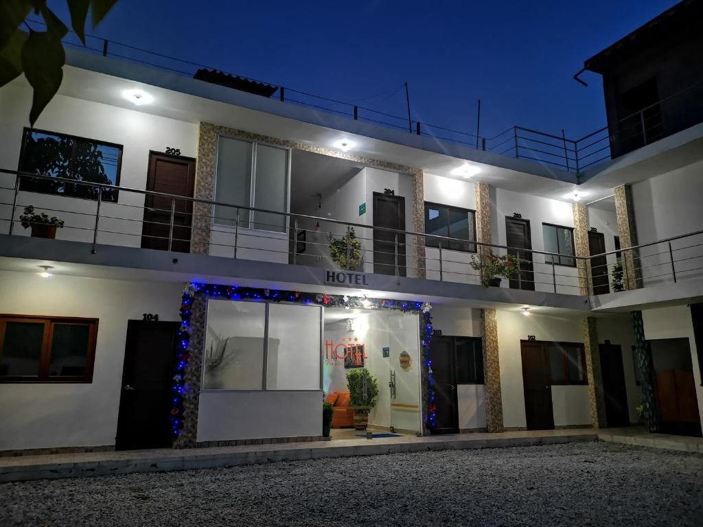 a building with a lit up front door at night at Hotel Paraiso Plaza in Puerto Triunfo